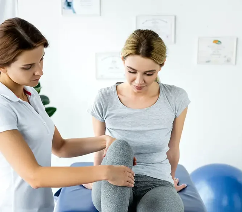 Clinician performing hands-on manual therapy on a patient's shoulder