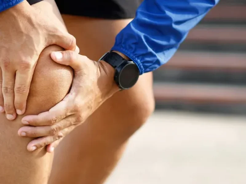 Clinician examining a patient's painful joint