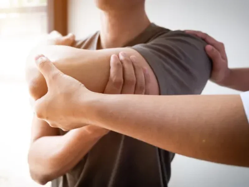 Clinician assessing a patient's shoulder range of motion