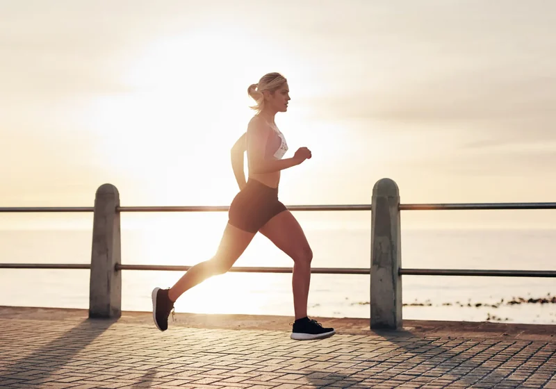 Physical therapist analyzing a runner's gait and stride mechanics
